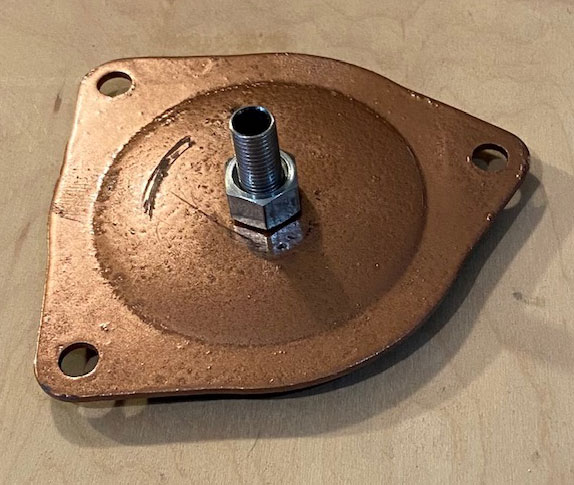 Ignition hole cover plate with breathing spigot